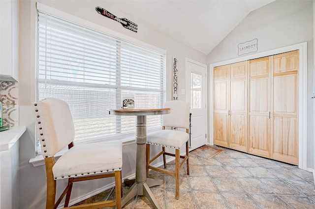 dining area with vaulted ceiling