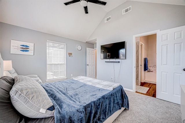 bedroom featuring wood-type flooring, ensuite bath, ceiling fan, and vaulted ceiling