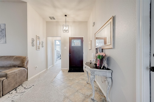 entrance foyer featuring light tile patterned floors and a chandelier