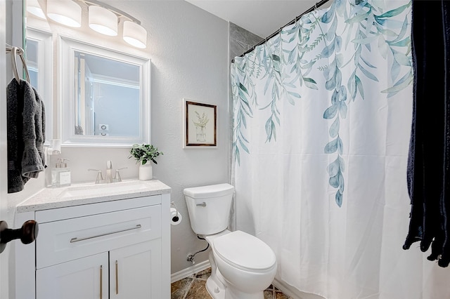 bathroom featuring toilet and vanity