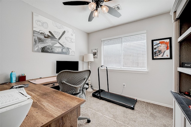 carpeted office featuring ceiling fan