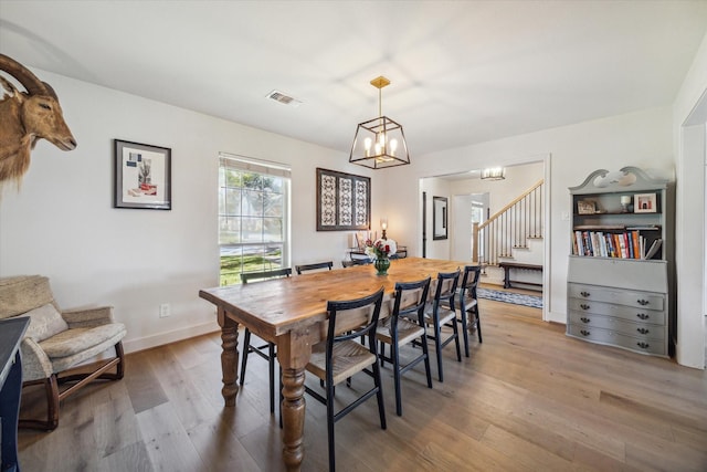 dining space with a chandelier and hardwood / wood-style floors