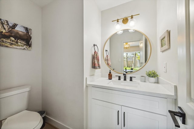 bathroom with toilet and vanity