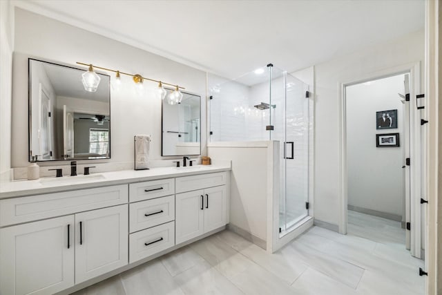 bathroom featuring an enclosed shower, vanity, and ceiling fan