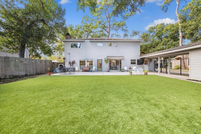 rear view of property with a patio area and a lawn