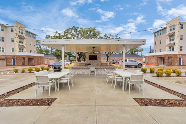 view of patio / terrace with outdoor dining space and a fireplace