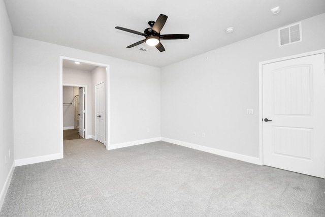 unfurnished bedroom with carpet flooring, visible vents, and baseboards