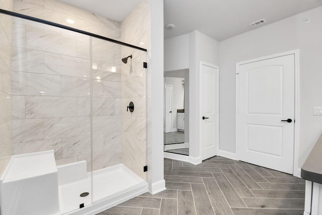 full bath featuring a stall shower, visible vents, and baseboards