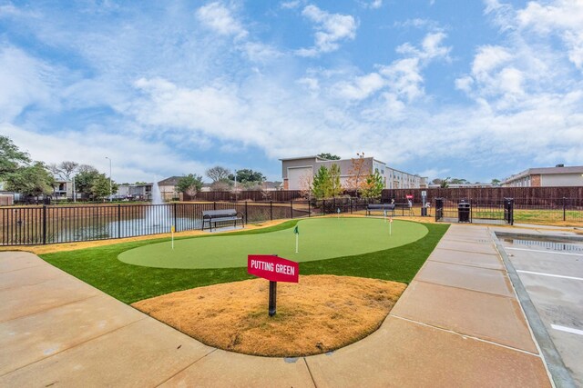 view of property's community with a water view and fence