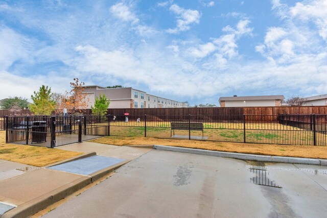 view of home's community featuring a gate, fence, and a yard