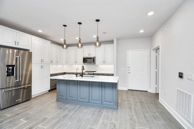 kitchen with white cabinets, visible vents, appliances with stainless steel finishes, and light countertops