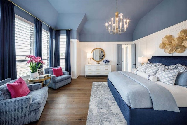 bedroom featuring an inviting chandelier, vaulted ceiling, and dark hardwood / wood-style floors