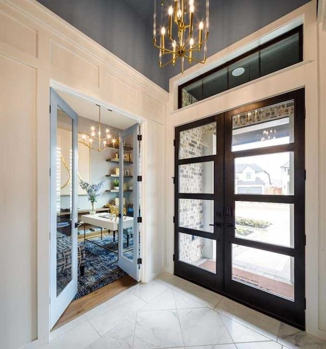 doorway to outside with french doors and a notable chandelier