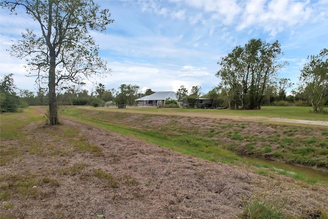 view of yard with a rural view