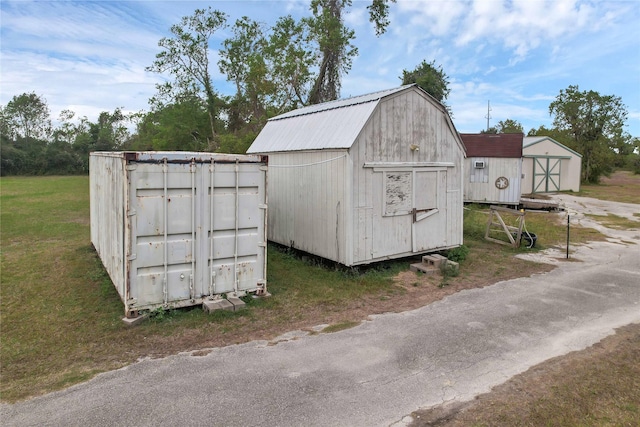 view of outdoor structure featuring a lawn