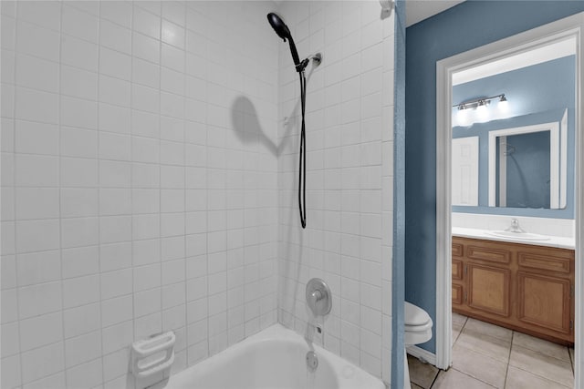 full bathroom with tile patterned floors, toilet, vanity, and tiled shower / bath combo