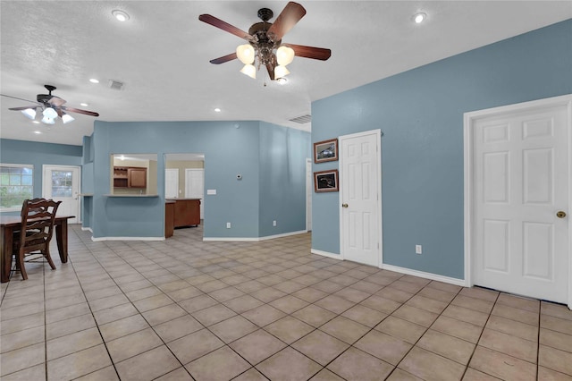 unfurnished living room featuring ceiling fan and light tile patterned floors