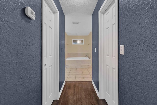 interior space with ceiling fan, light tile patterned floors, and vaulted ceiling