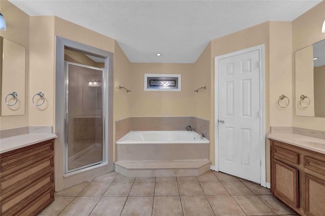 bathroom with shower with separate bathtub, vanity, and tile patterned flooring