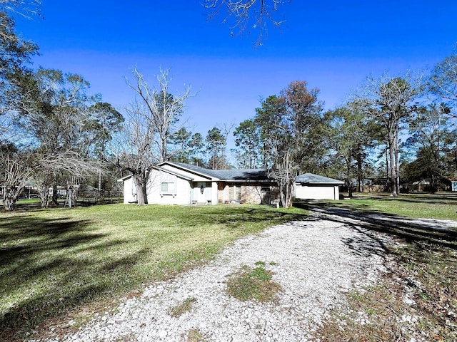 exterior space featuring a garage and a front yard