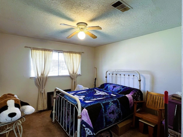 carpeted bedroom featuring a textured ceiling and ceiling fan