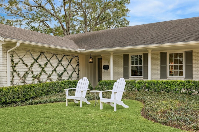 doorway to property with a yard