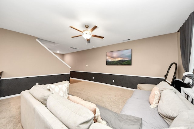 carpeted living room with ceiling fan