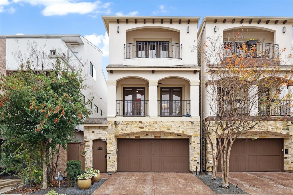 mediterranean / spanish-style house with a balcony and a garage