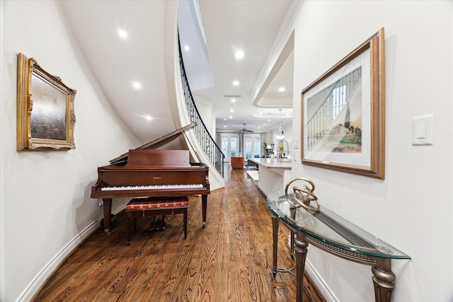 misc room with wood-type flooring and ornamental molding