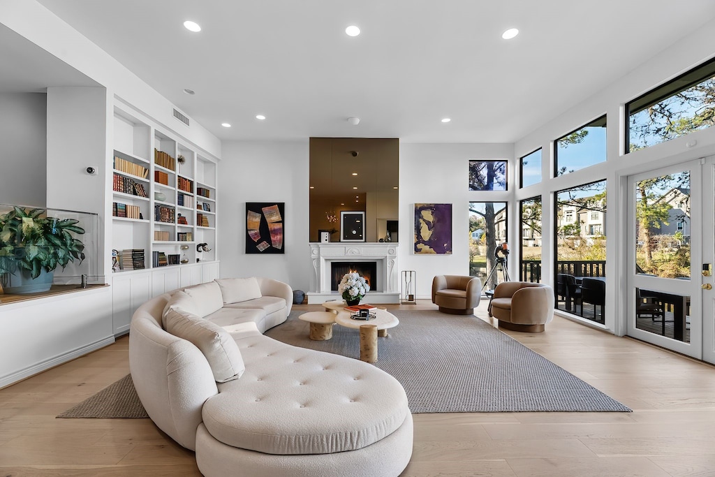 living room with light wood-type flooring and built in features