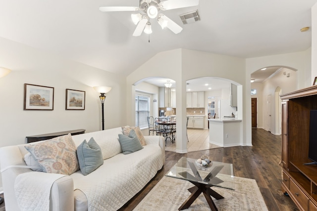 living room featuring ceiling fan, vaulted ceiling, and dark hardwood / wood-style floors