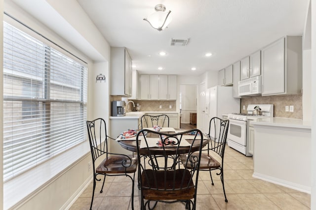 dining room featuring light tile patterned floors and sink