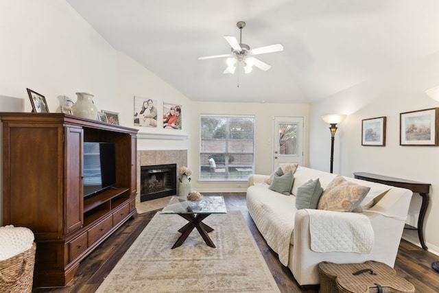 living room with lofted ceiling, a fireplace, ceiling fan, and dark hardwood / wood-style flooring