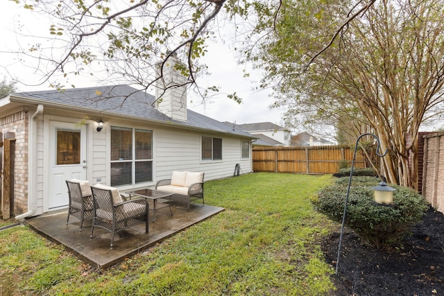 rear view of property with a patio and a lawn