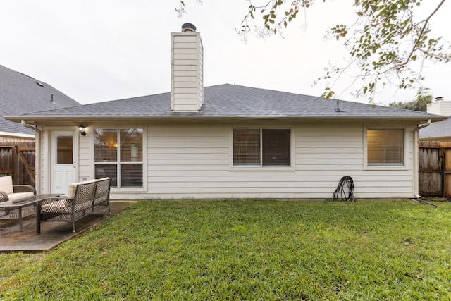 rear view of house featuring a lawn