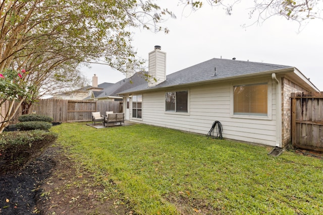 rear view of house with a patio area, a yard, and an outdoor living space