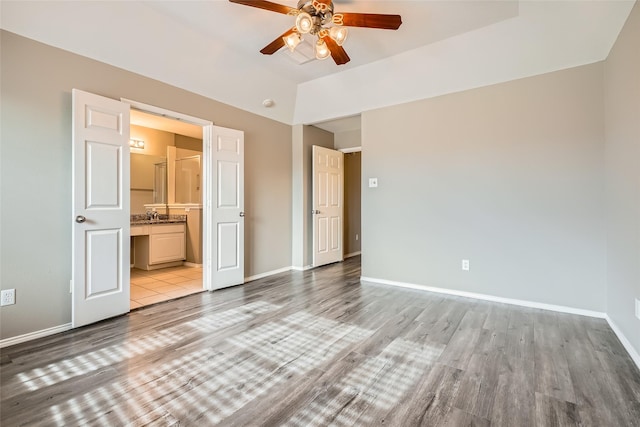 unfurnished bedroom with ceiling fan, light hardwood / wood-style flooring, and ensuite bath