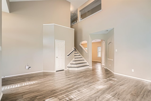 interior space featuring light hardwood / wood-style floors and a towering ceiling