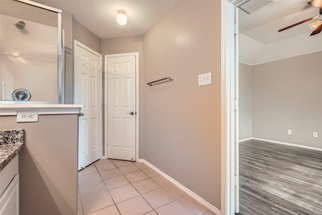 bathroom with ceiling fan, tile patterned floors, and vanity