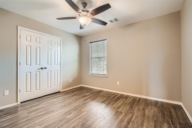 unfurnished bedroom with ceiling fan, light hardwood / wood-style floors, and a closet