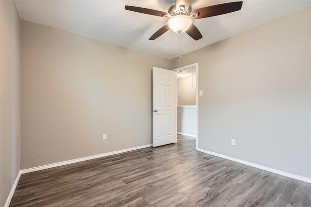 empty room with ceiling fan and hardwood / wood-style floors