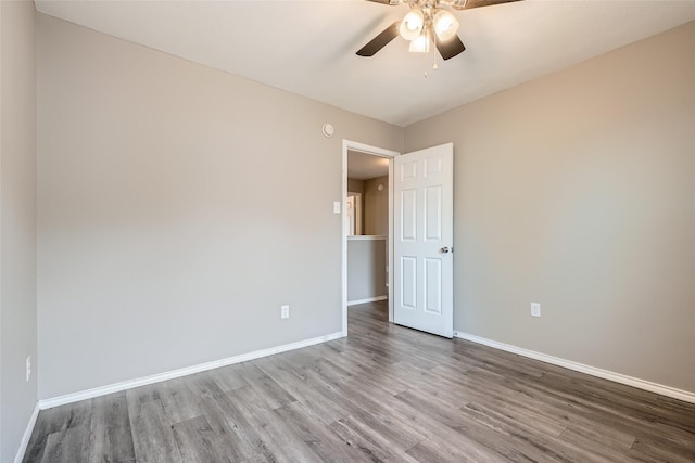 unfurnished room with ceiling fan and hardwood / wood-style flooring