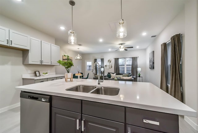 kitchen featuring white cabinets, gray cabinetry, ceiling fan, sink, and stainless steel dishwasher