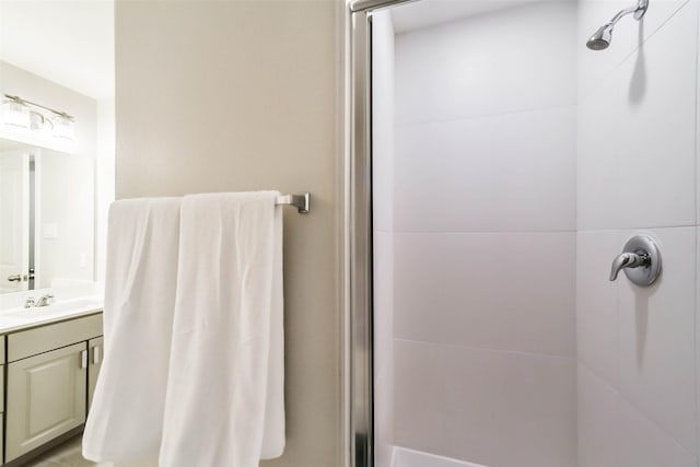 bathroom featuring an enclosed shower and vanity