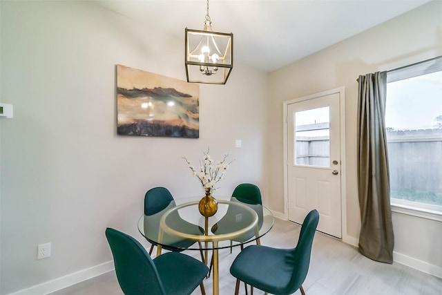 dining area featuring a notable chandelier and light hardwood / wood-style floors