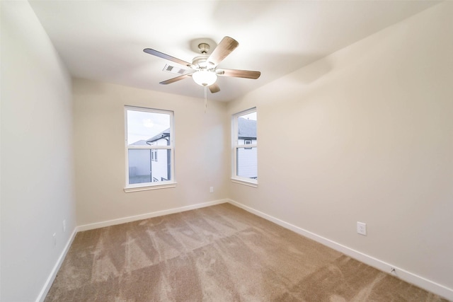 empty room with light colored carpet and ceiling fan