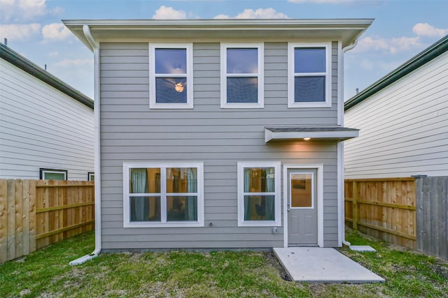 rear view of house with a lawn