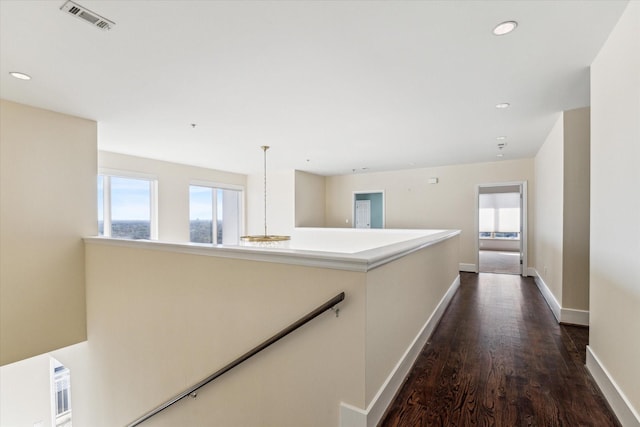 hallway with dark hardwood / wood-style floors