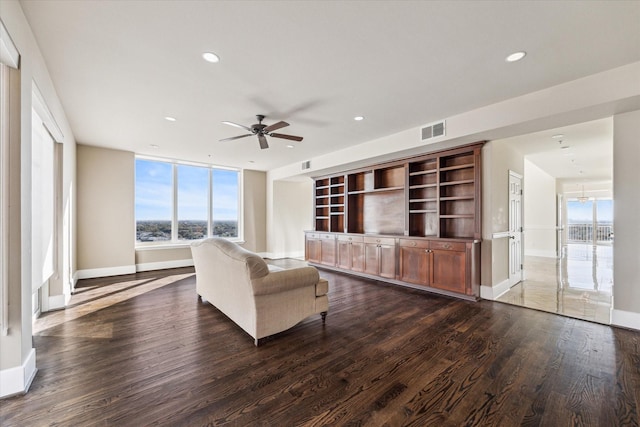 unfurnished living room with dark hardwood / wood-style flooring and ceiling fan with notable chandelier