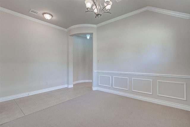 tiled spare room with an inviting chandelier and ornamental molding